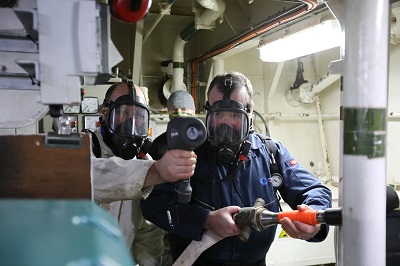 Person using machinery in full face mask