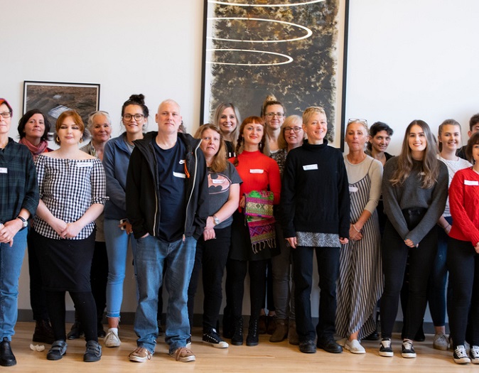 Group of people standing in front of art