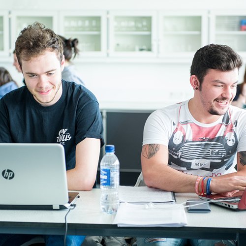 students sitting at a desk