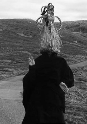 Person wearing a straw mask and helmet