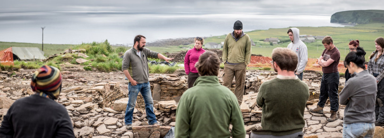 Group of people standing in a dig site