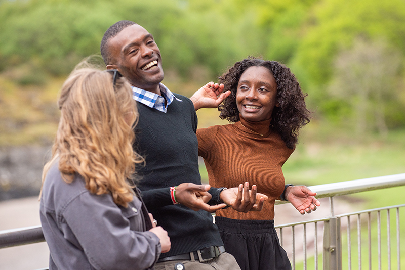 Three people laughing and smiling