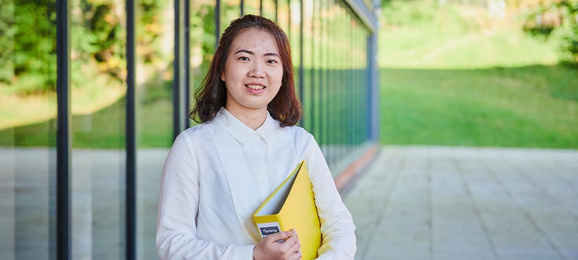 Qian standing outside UHI Perth campus