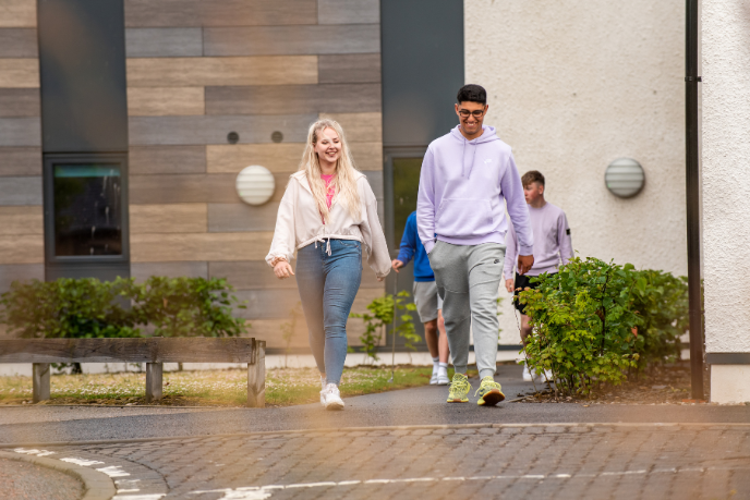 Two students walking outside student accommodation